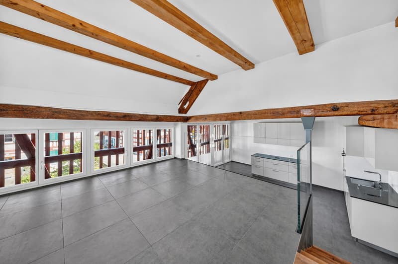 large room, wooden beams, large windows, balcony, tiled floor, modern kitchen