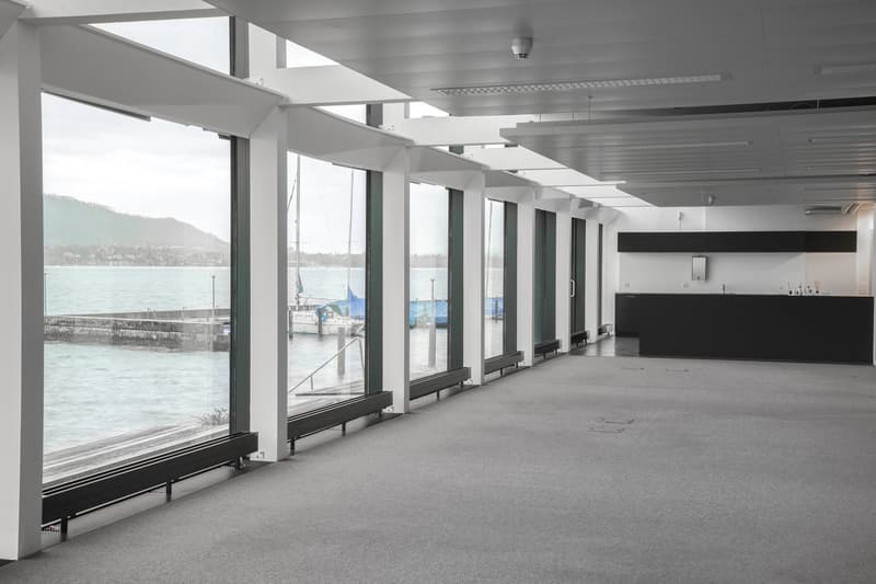 large windows, sea view, metal railing, white ceiling, white walls