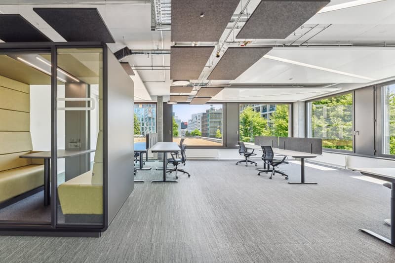 modern office layout, glass walls, tables, chairs, large windows, urban view