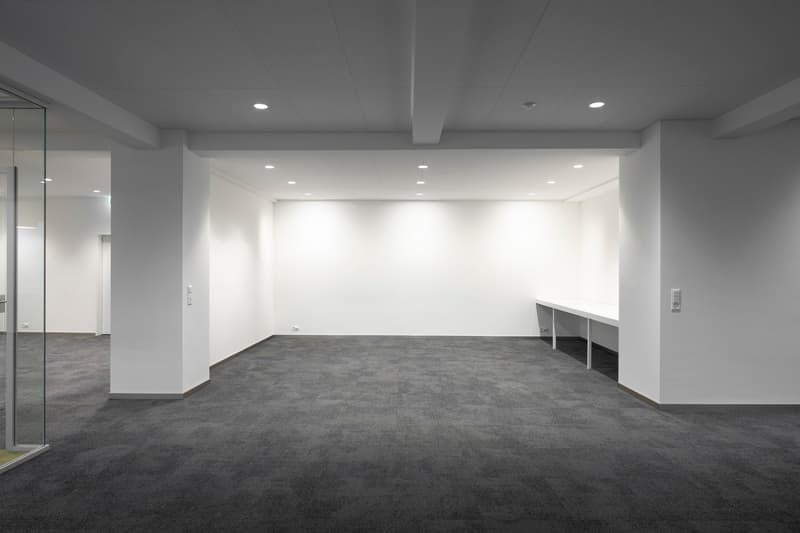 empty room, gray floor, white walls, glass door, white ceiling, no furniture