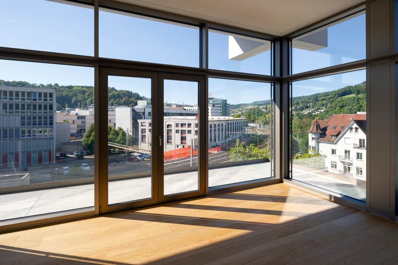 large windows, wooden floor, city view