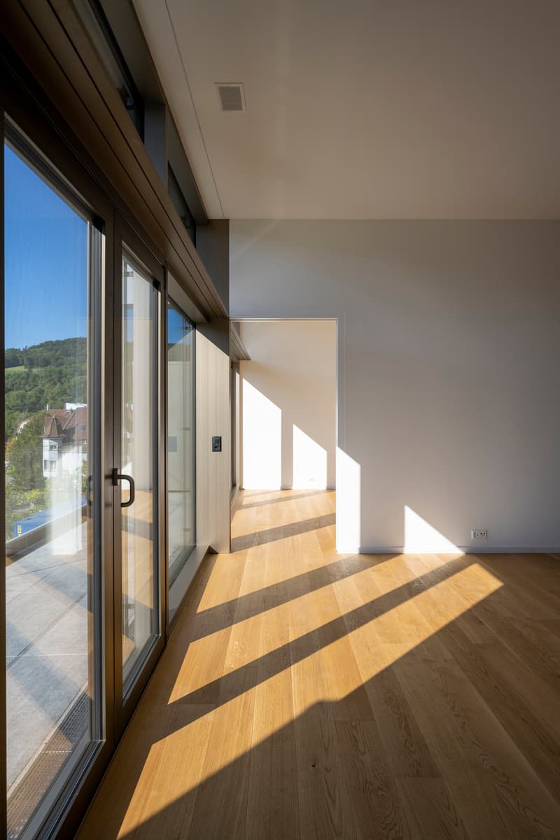 empty room, wooden floor, sliding glass doors, white walls, balcony view