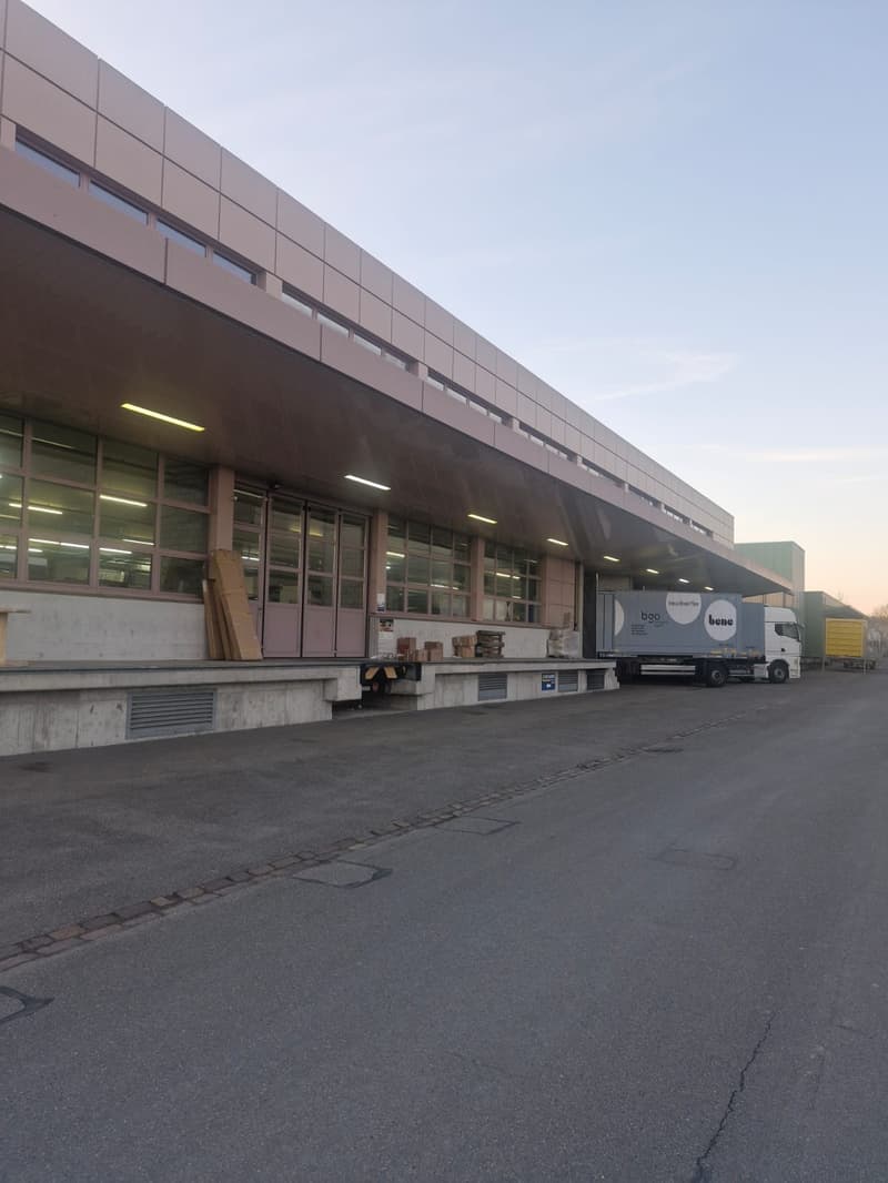 industrial building, delivery truck parked in front