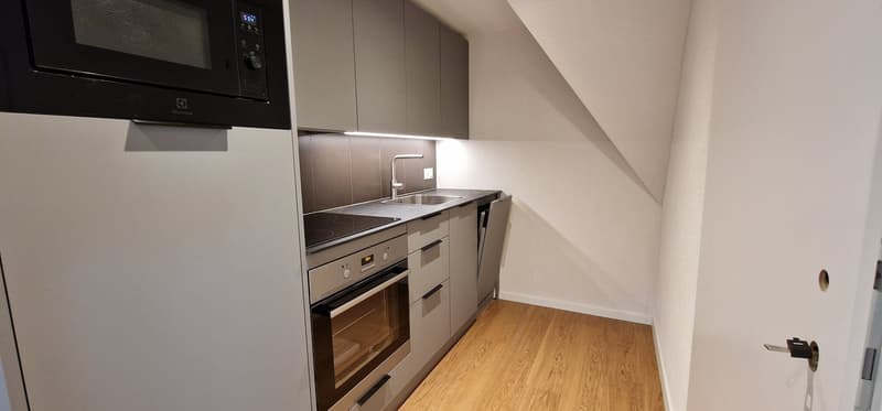 small kitchen with sink, microwave, stove, oven, dishwasher, refrigerator, wooden floor