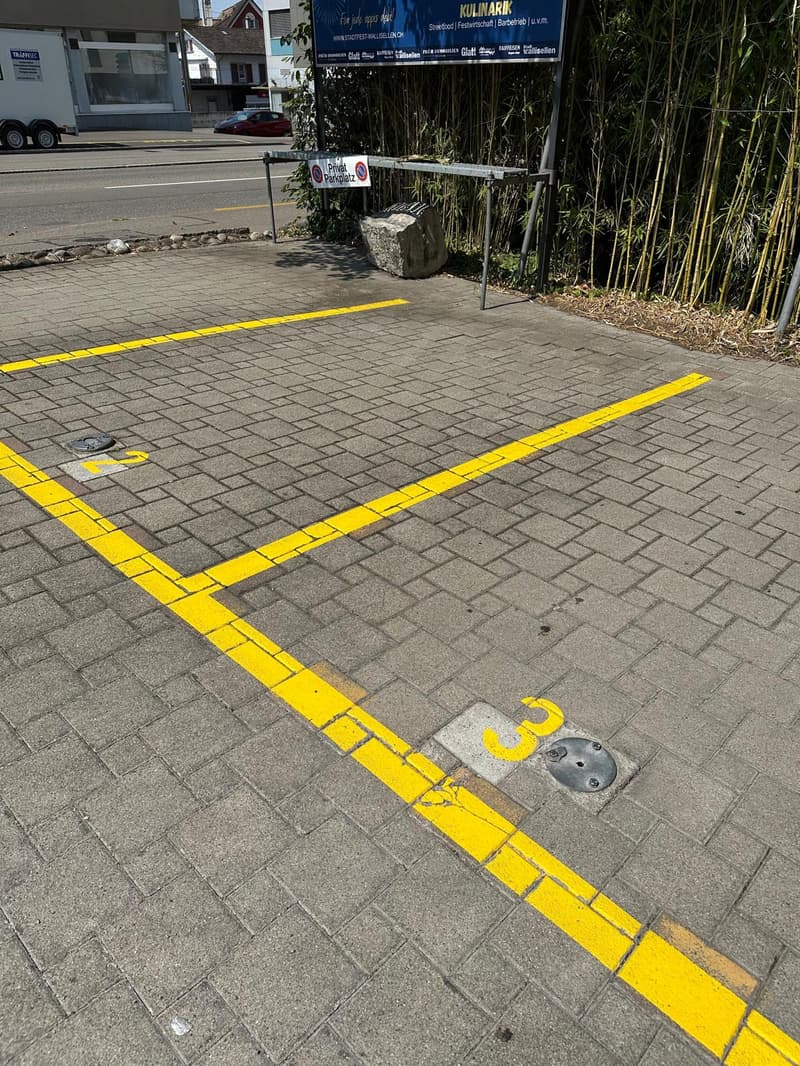 Brick-paved parking lot with clearly marked parking spaces