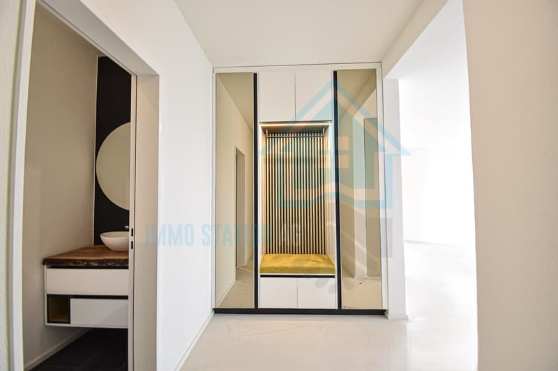 Einladendes Entrée mit eleganter, massgeschneiderter Garderobe für optimalen Stauraum