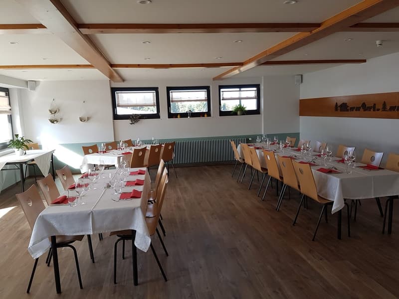 long tables, wooden chairs, white tablecloths, potted plants on window sills, wooden beams on ceiling, wooden wall panel
