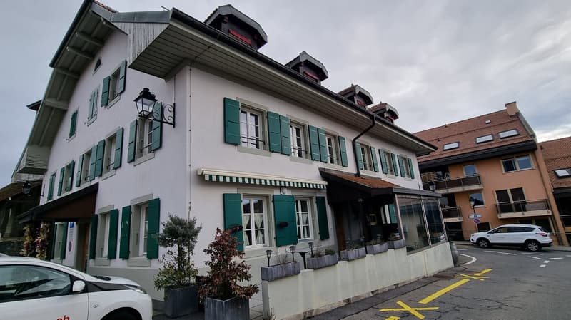 3 story house, white exterior, green shutters, awnings, plants, street view