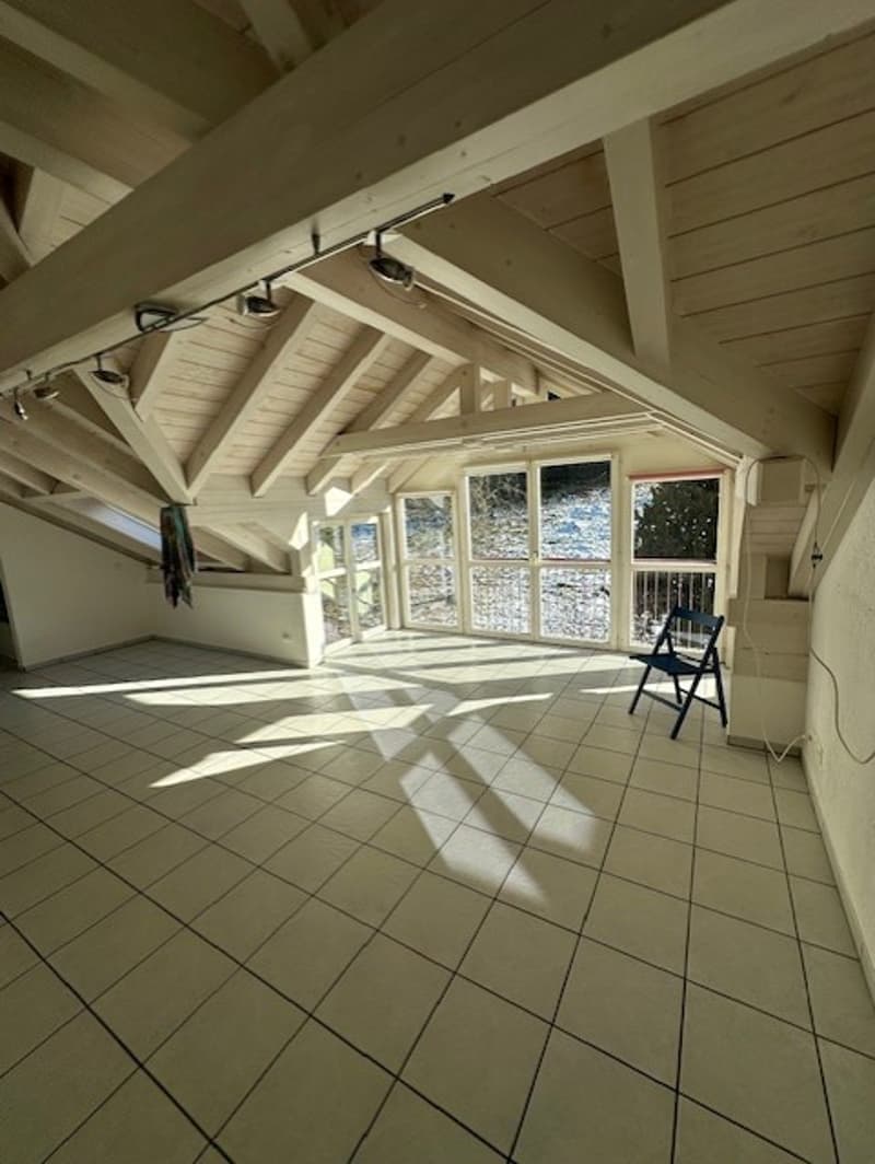 tiled floor, exposed wooden beams, large windows, empty room