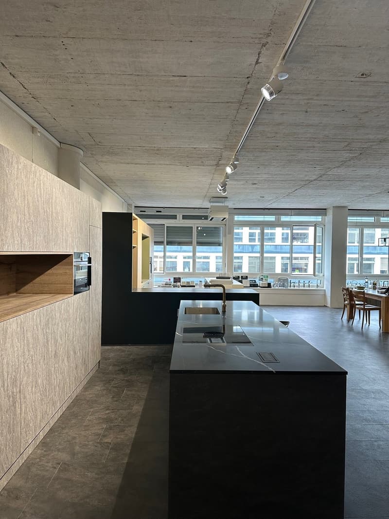 modern kitchen, dark countertops, wooden cabinets, large sink, oven, ceiling track lighting, windows, open space layout
