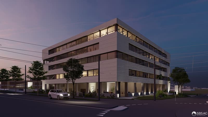 Modern office building with glass facade, multiple floors, illuminated at night, car parked in front
