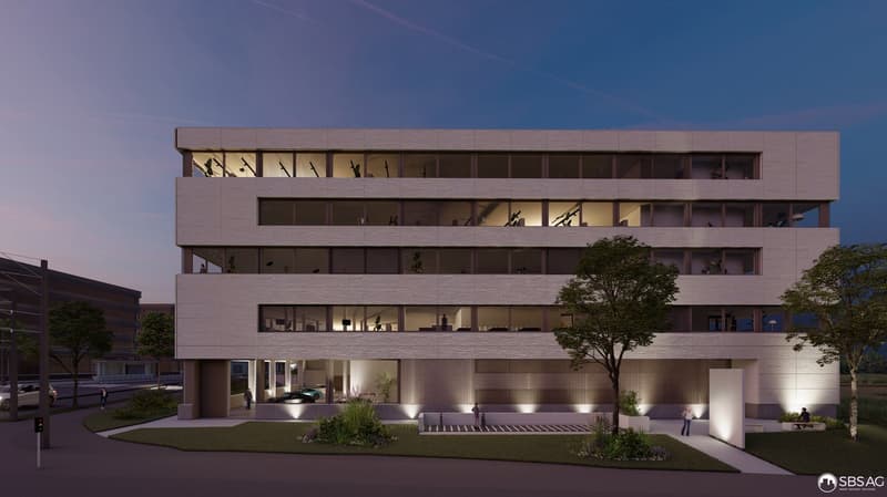 Modern building with multiple floors, large windows, balconies, and a parking area.