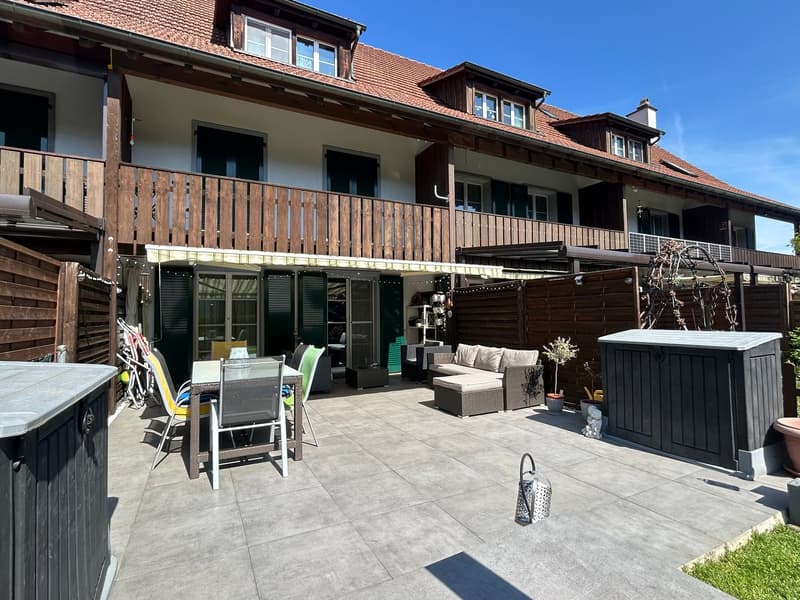 2 story house, wooden balcony, patio with table and chairs, outdoor seating, potted plants, storage box, wooden fence