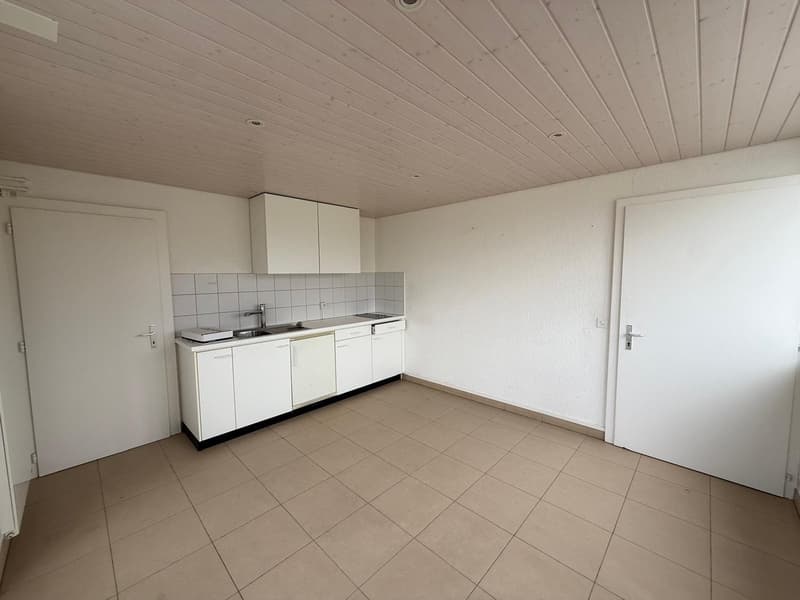 empty kitchen with tiled floor, white cupboards, sink, and dishwasher
