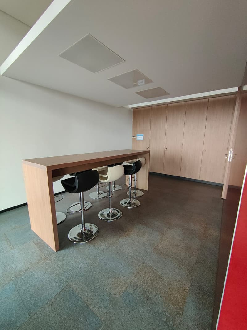 empty room with a long desk and six chairs