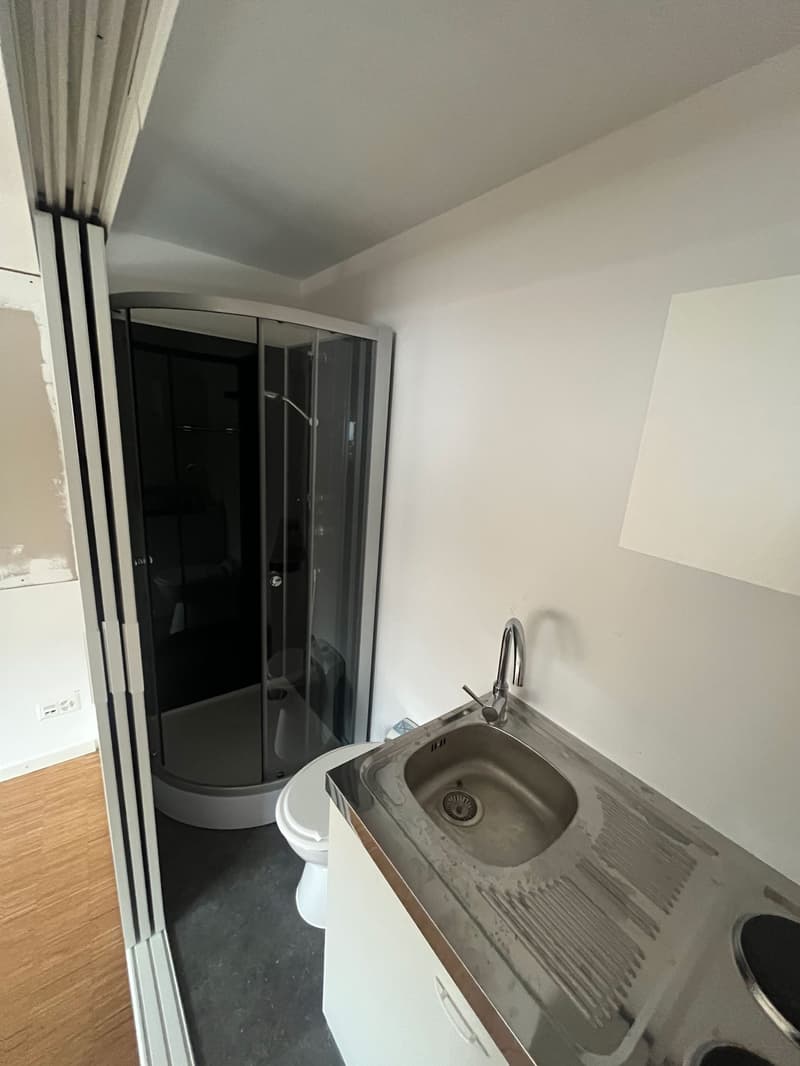 Small bathroom with shower, sink, and toilet