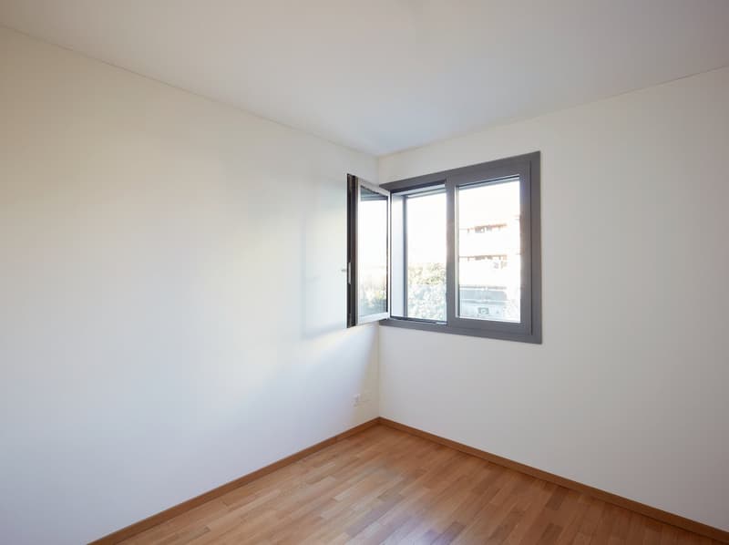 empty room, white walls, wooden floor, open window, power outlet