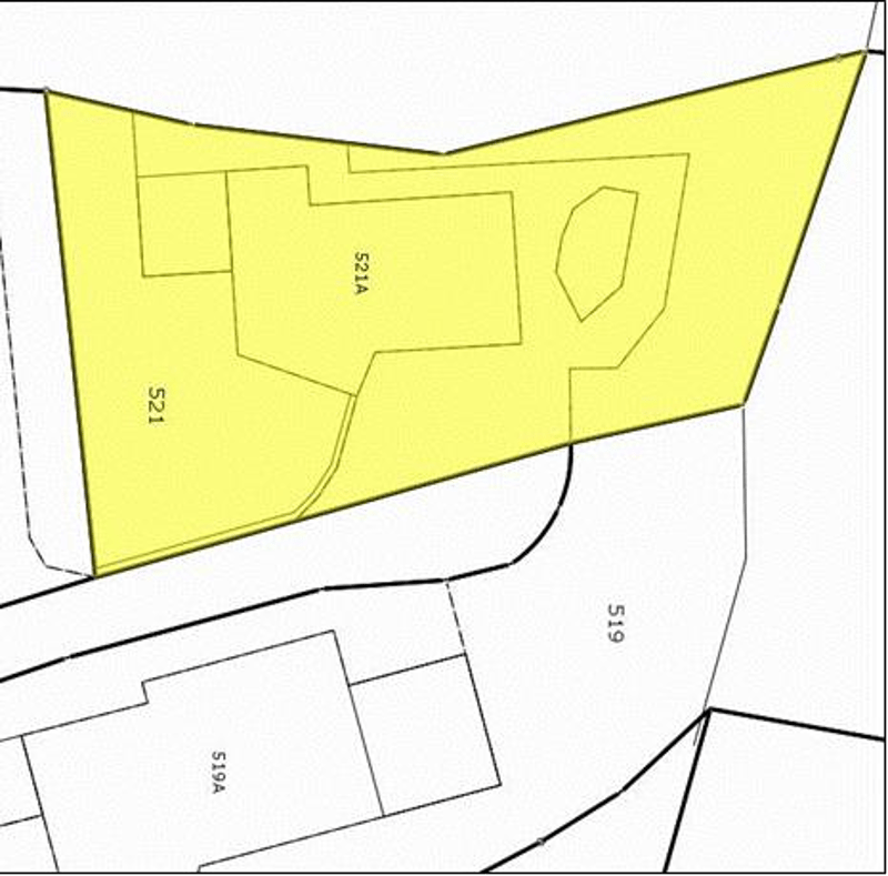 Building outline with interior spaces, street front, parking area