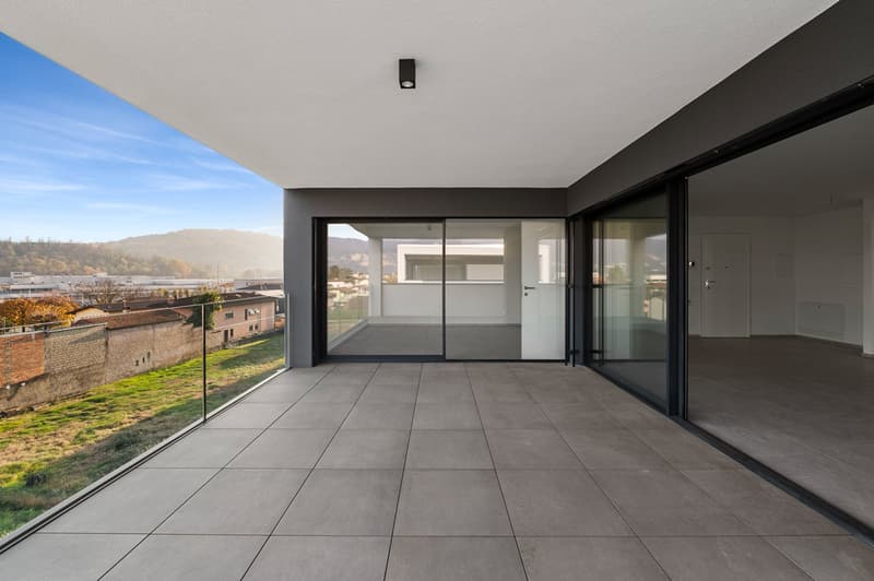 glass doors, tiled floor, metal railings, city skyline view