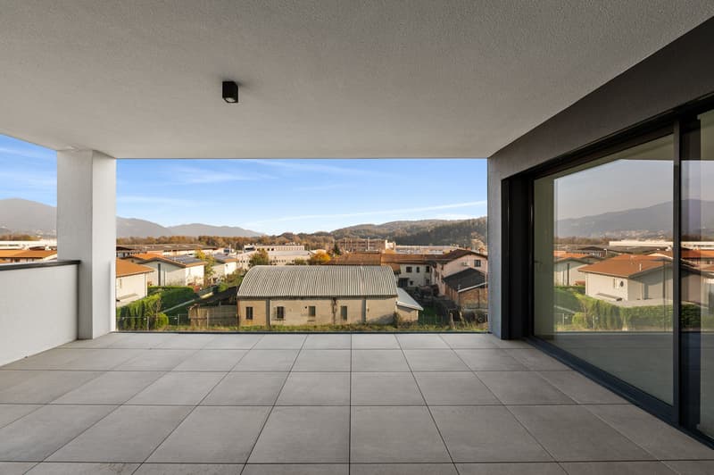 Apartement with balcony, large windows, view of a town with mountains