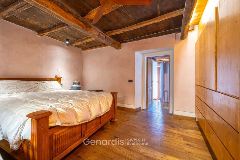 wooden bed, wooden floor, wooden ceiling, pink walls, lamp, wooden wardrobe