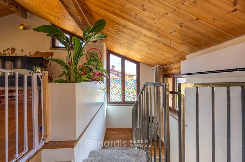 wooden ceiling, wooden floor, staircase, large plant, stained glass window, air conditioner
