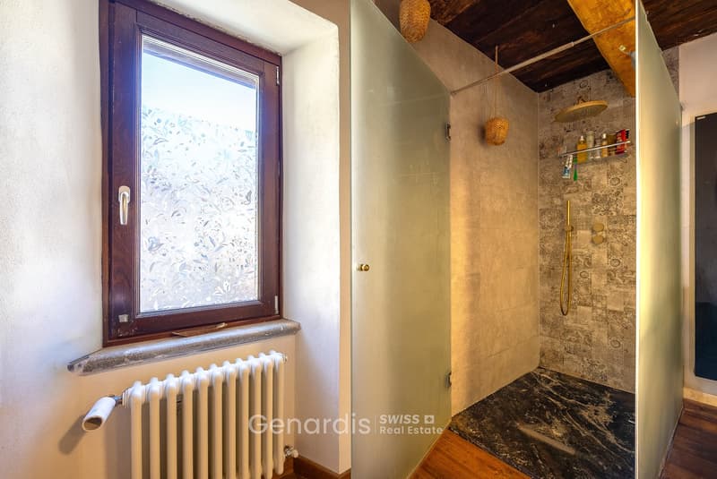 bathroom with window, radiator, glass door, shower, wooden floor