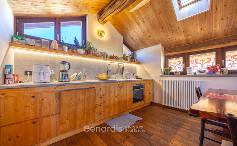 kitchen with wooden cabinets, granite countertop, modern appliances, wooden floor, wooden ceiling, windows, radiator