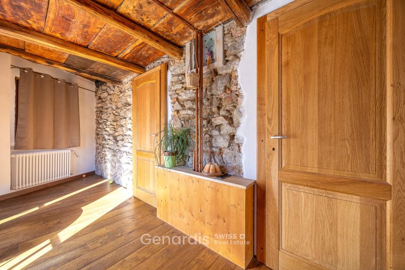 wooden floor, stone wall, wooden door, radiator, wooden shelf, plant, basket, cell phone