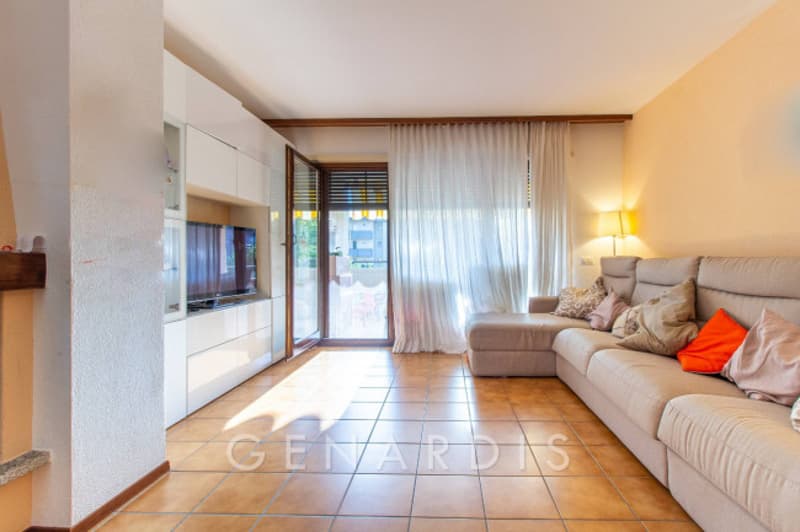 Fireplace, large sofa, TV, white curtains, tiled floor