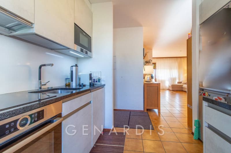 modern kitchen with white cabinets, granite countertop, stainless steel appliances, sink, faucet, microwave, dishwasher, oven