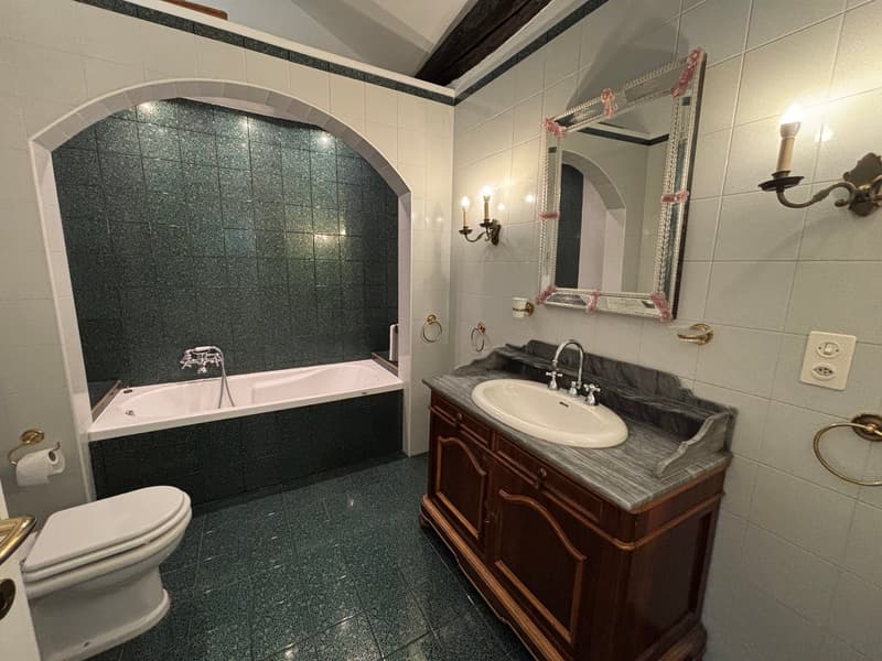 Bathroom with bathtub, sink, mirror, and toilet
