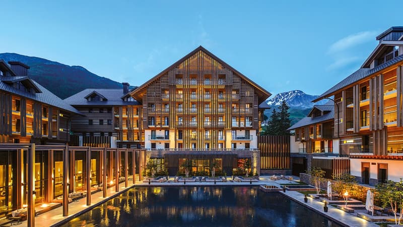 modern architectural design, large swimming pool, multiple buildings, mountain view