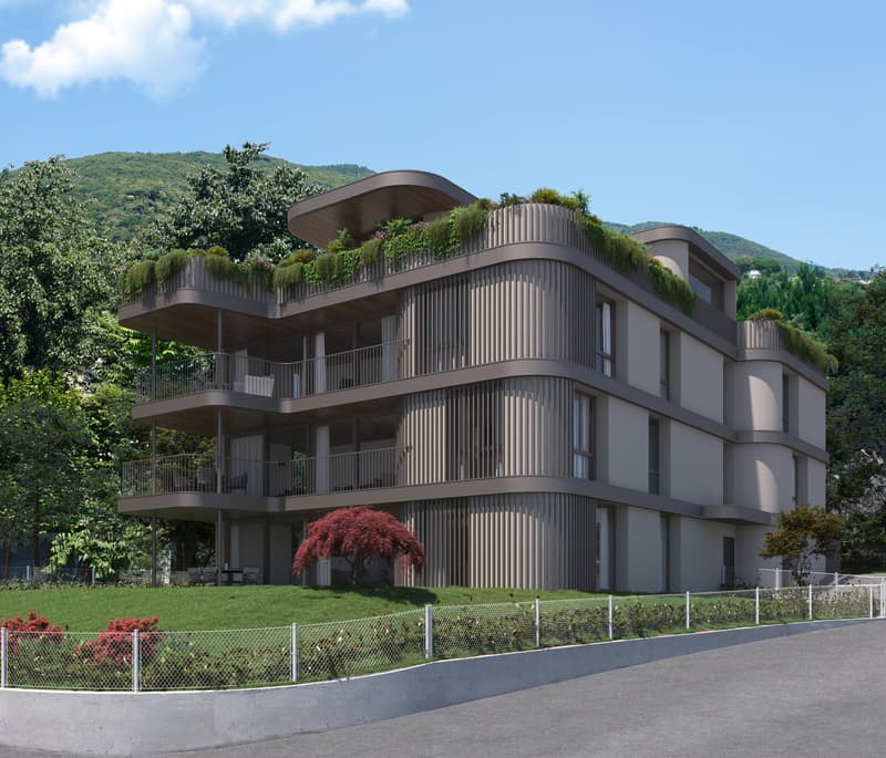 Multi-story apartment building with curved, terraced balconies and a green roof. The building has a modern, organic design with a mix of concrete and wood-like materials. It is surrounded by lush greenery and landscaping, with a view of the hills in the b