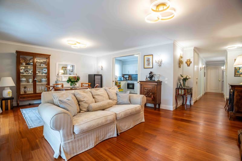 white sofa, side tables, cabinet, hardwood floors, decorative pieces, white walls, natural light