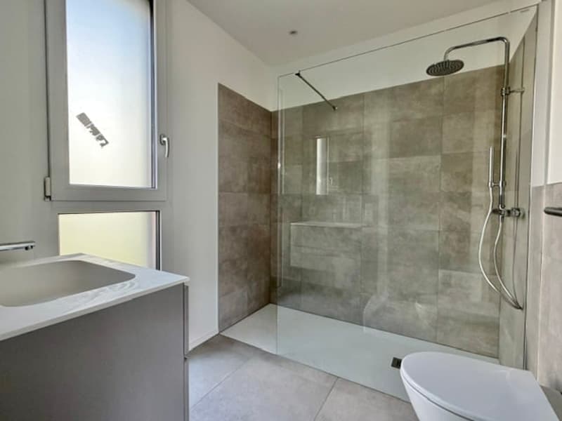 modern bathroom with shower, sink, and toilet