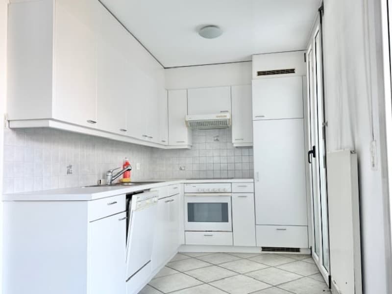 modern kitchen with built-in appliances and white cabinetry