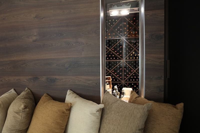 modern interior, wooden walls, lounge seating with pillows, wine storage display