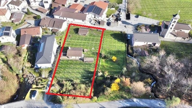 House with a garden, surrounded by other houses, solar panels on the roof, aerial view