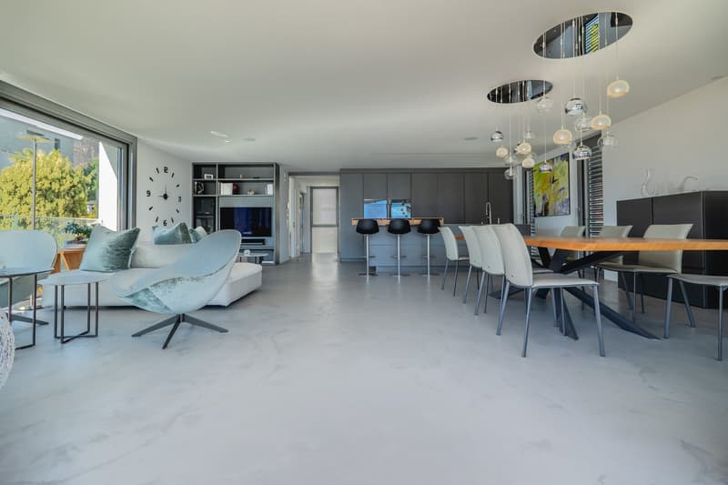 modern open plan living and dining area, large windows, white marble flooring, contemporary furniture, chandeliers