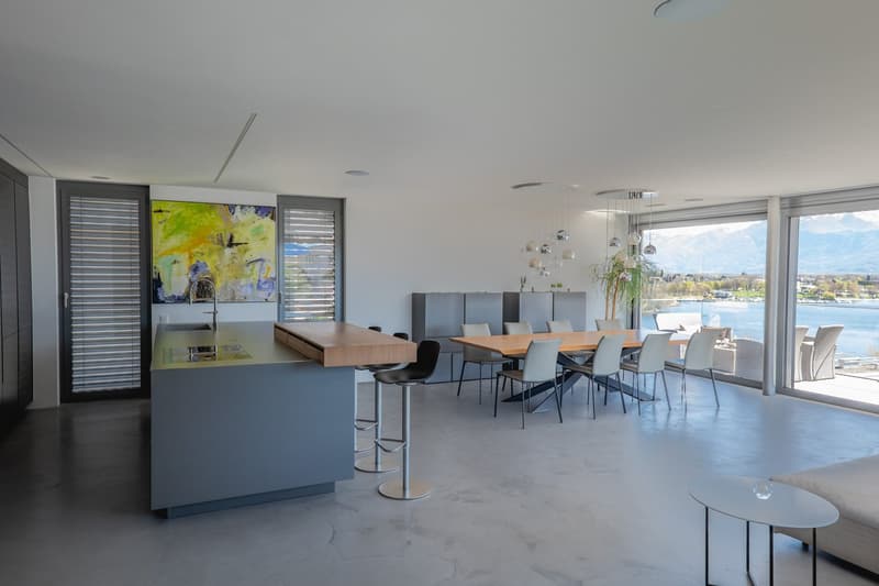 modern kitchen with island, dining area with large windows, modern furniture, artwork