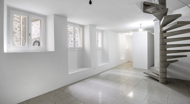 Empty room, white walls, 3 windows, tiled floor, spiral staircase