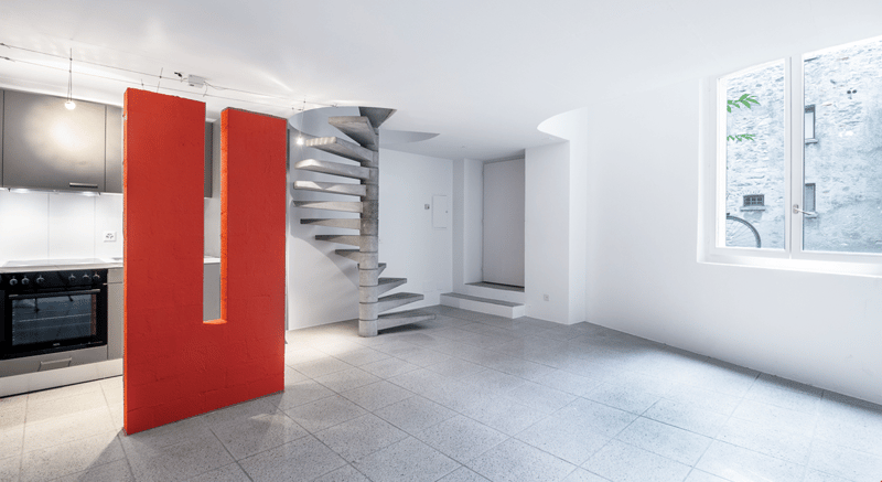 empty room, concrete staircase, kitchen, white walls, gray flooring