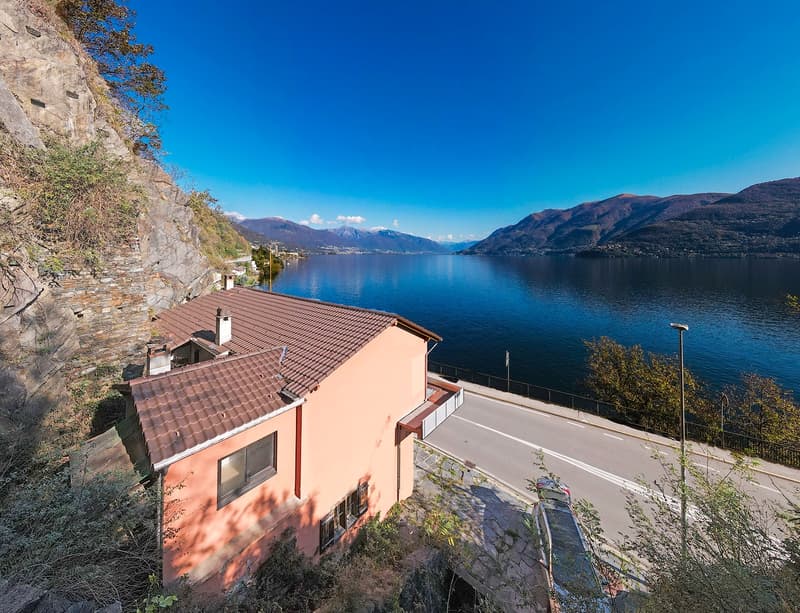 2 story house, brown roof, lake view, mountains
