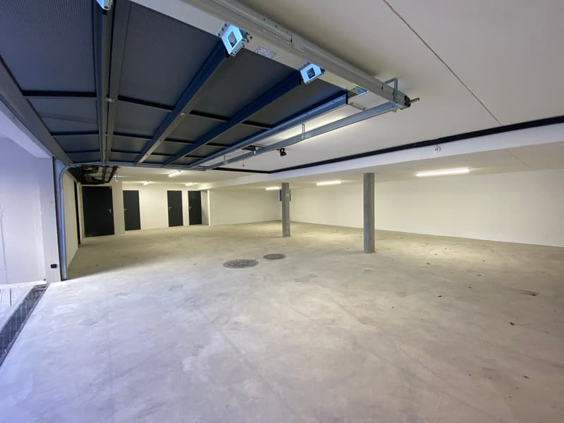 Empty garage with concrete floor, metal ceiling, and three parking spaces