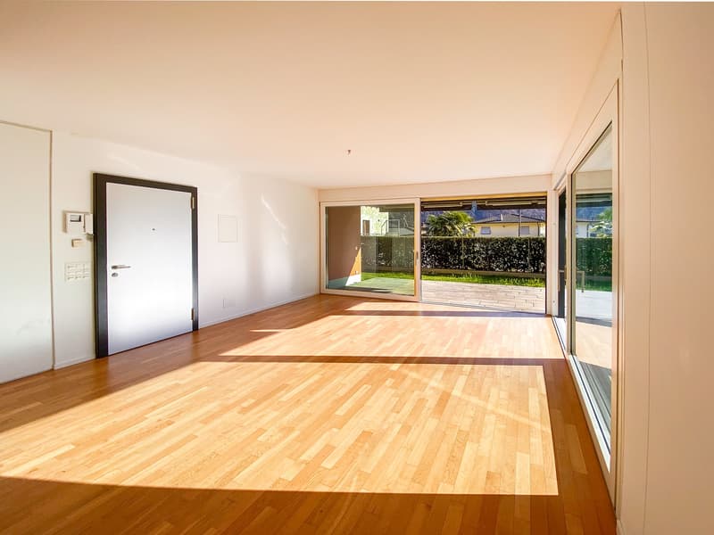 empty room, wooden floor, sliding glass doors, white walls, balcony