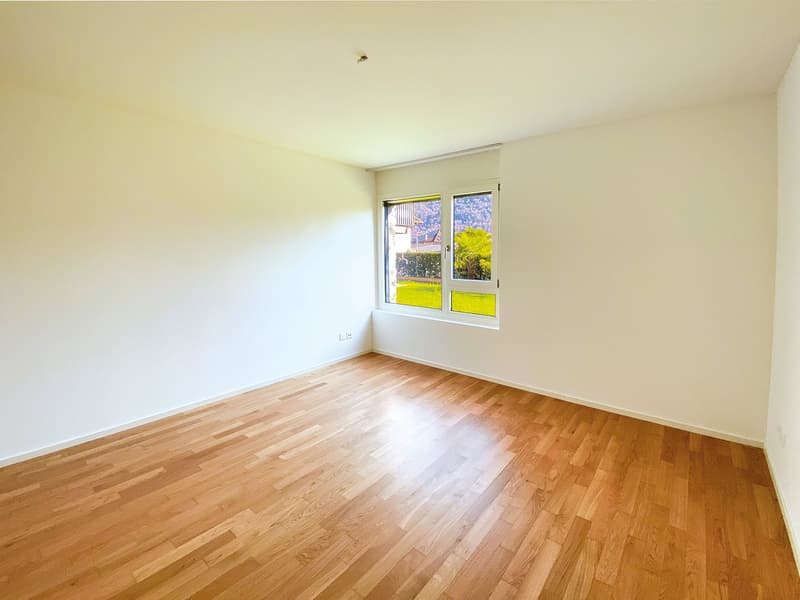 empty room, wooden floor, white walls, large window with view