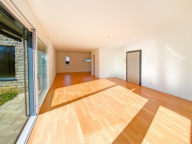 empty room, wooden floor, sliding glass doors, white walls, white ceiling, two doors