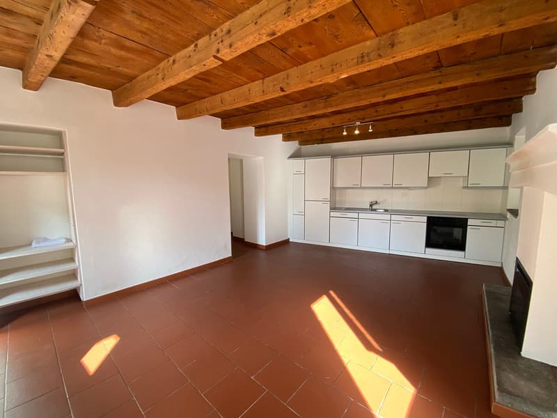 modern open kitchen, white cabinets, stainless steel appliances, red tile flooring, wooden ceiling, fireplace
