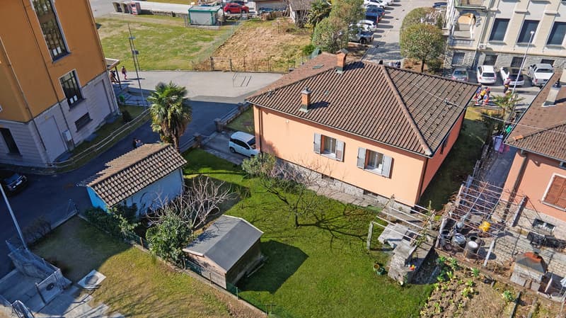 2 story house, brown roof, brown garage, small building, garden, green grass
